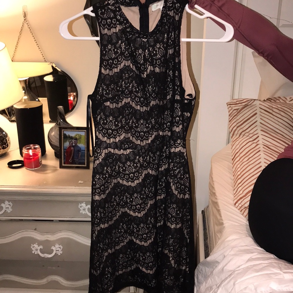 Black lace dress. Form fitting on top